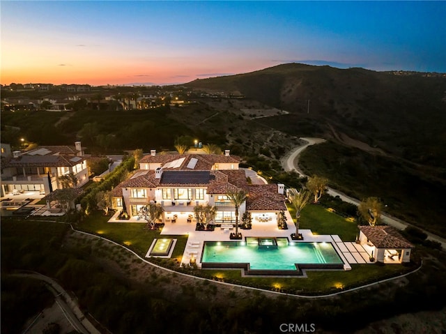 birds eye view of property featuring a mountain view