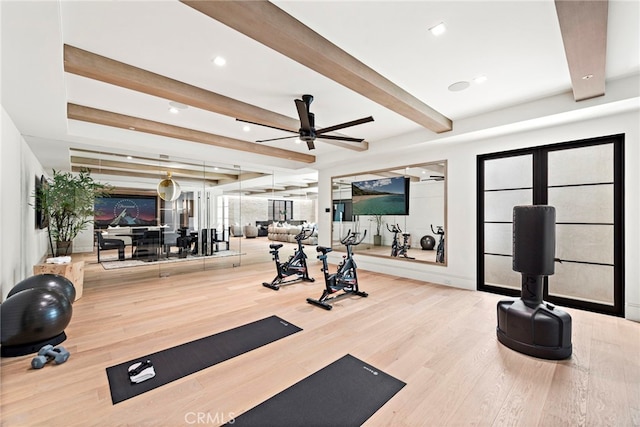 gym featuring ceiling fan and hardwood / wood-style flooring