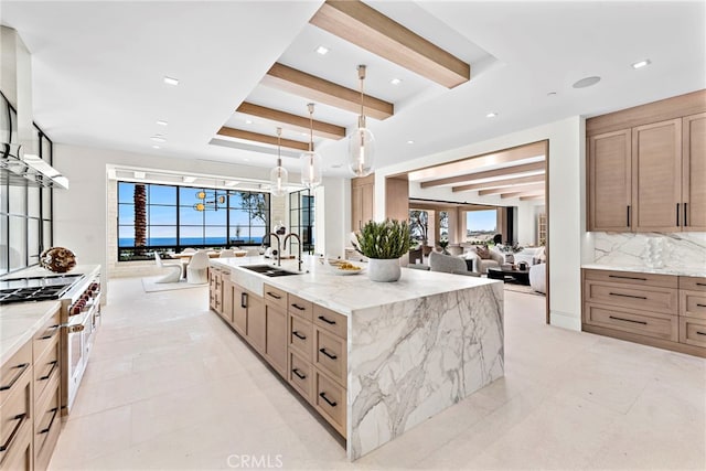 kitchen with sink, plenty of natural light, pendant lighting, and backsplash