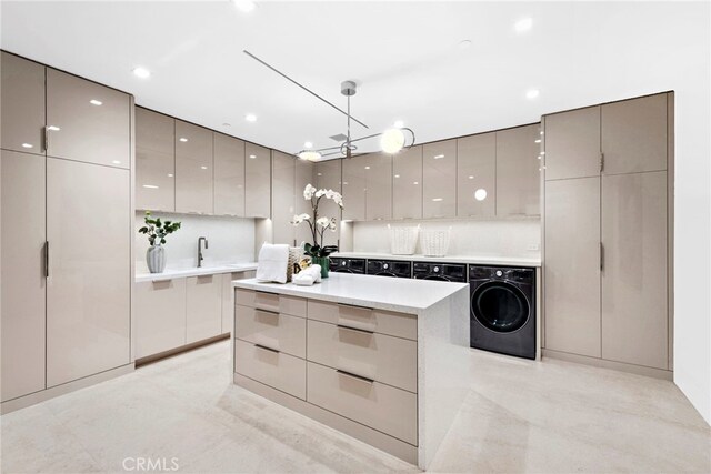 kitchen with backsplash, a center island, washer / dryer, pendant lighting, and gray cabinetry