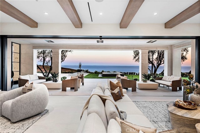 patio terrace at dusk with an outdoor living space and a water view