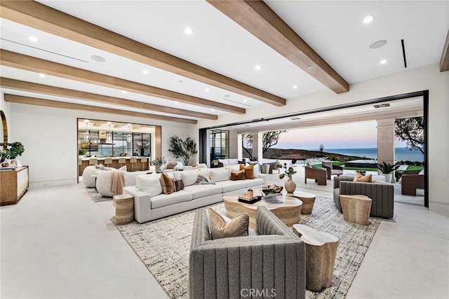 living area featuring recessed lighting, beamed ceiling, baseboards, and decorative columns