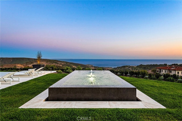 view of home's community featuring a yard and a water view