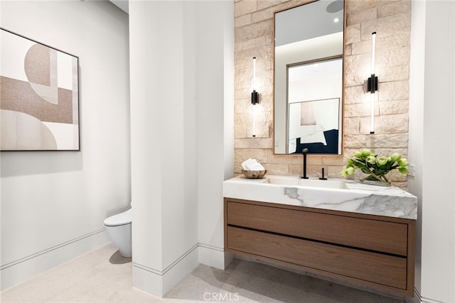 bathroom featuring a shower, vanity, tile patterned flooring, and toilet