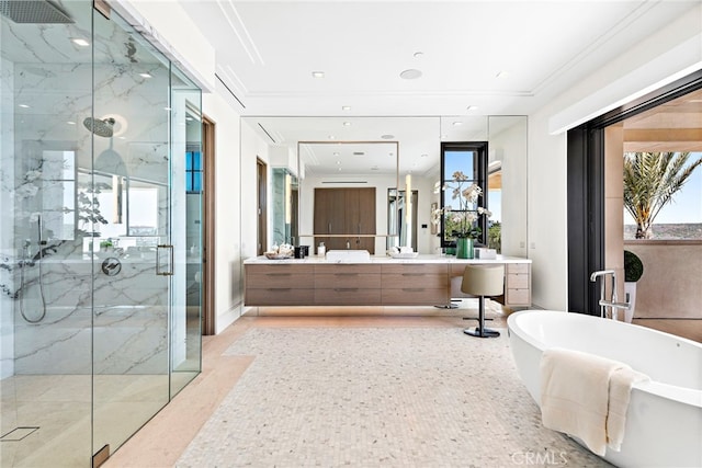 full bathroom featuring a marble finish shower, a soaking tub, ornamental molding, and vanity