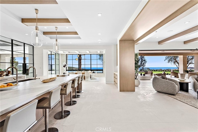 interior space with a raised ceiling, beamed ceiling, and recessed lighting