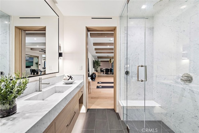 ensuite bathroom featuring vanity, a shower stall, tile patterned floors, and connected bathroom