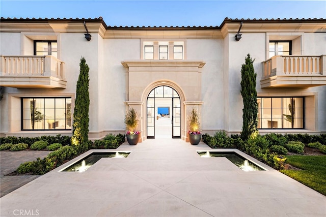 doorway to property featuring stucco siding