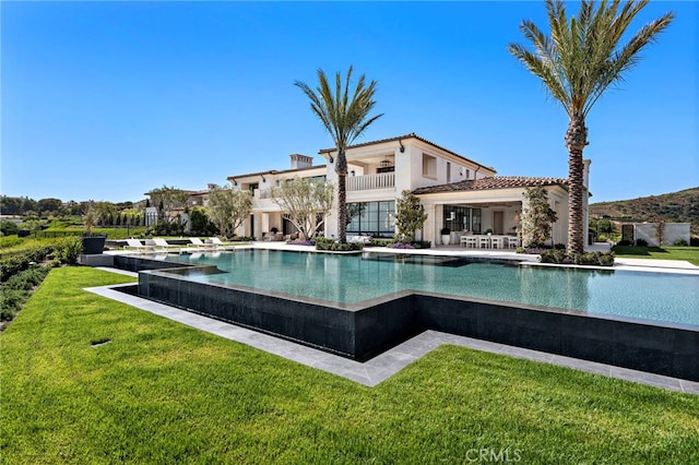 view of pool with a yard and a patio area