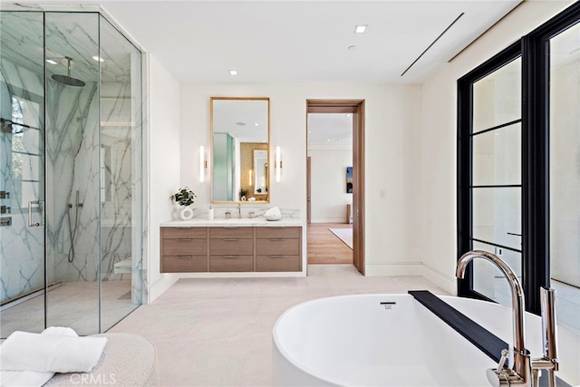 bathroom with vanity, shower with separate bathtub, and tile patterned floors