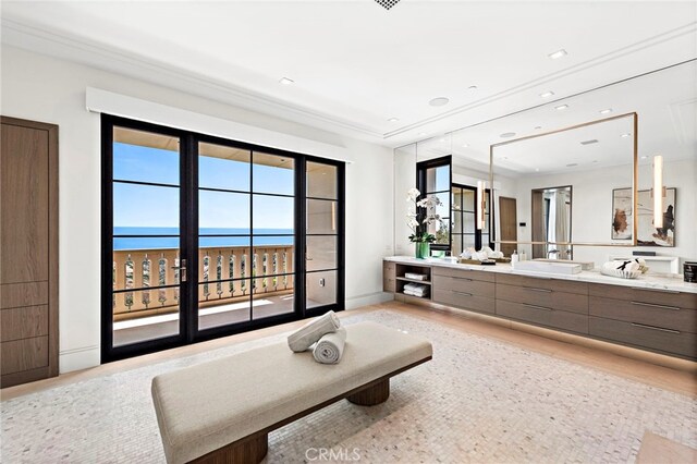 bathroom with a water view, hardwood / wood-style floors, and vanity