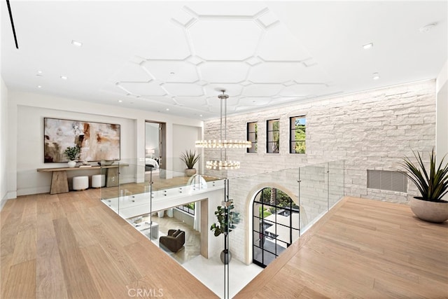 interior space with a notable chandelier, wood finished floors, and recessed lighting