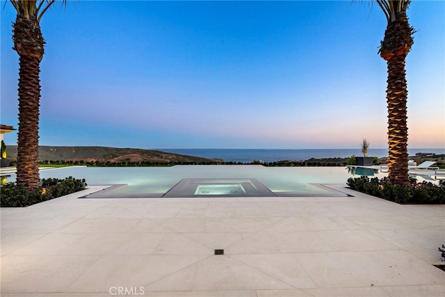 view of swimming pool featuring a water view