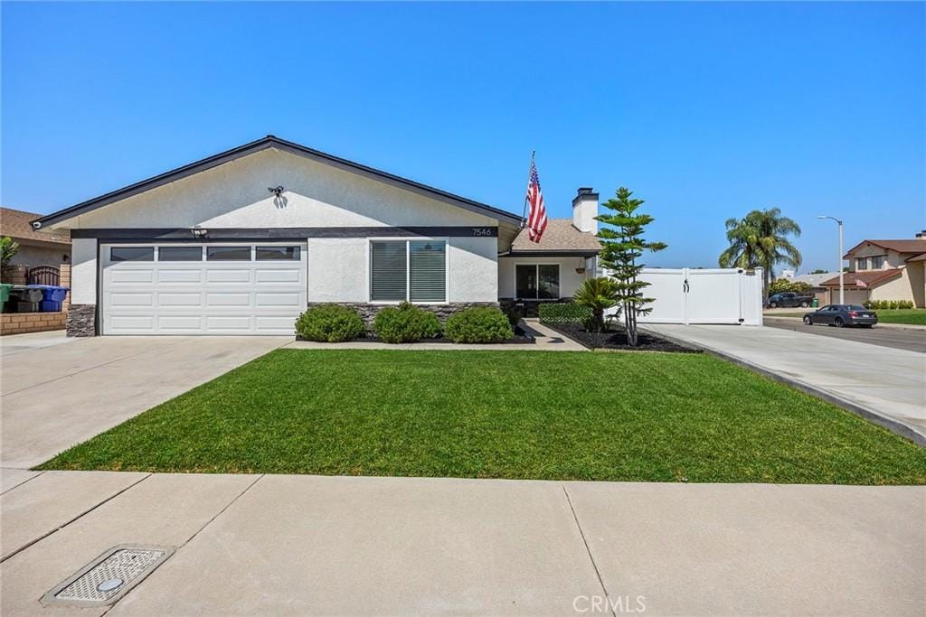 ranch-style house with a front yard and a garage