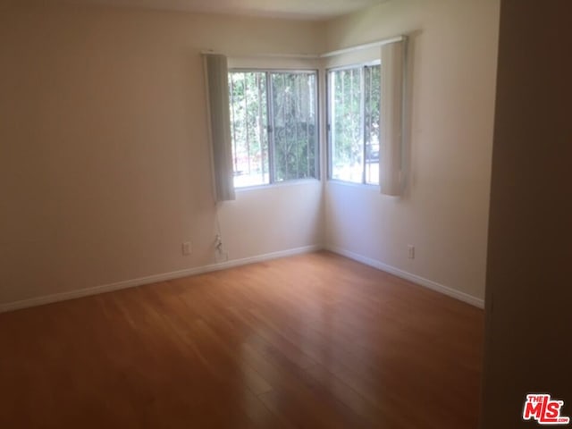 spare room with hardwood / wood-style flooring