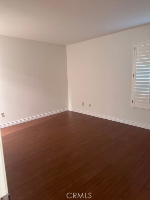 spare room with dark hardwood / wood-style flooring