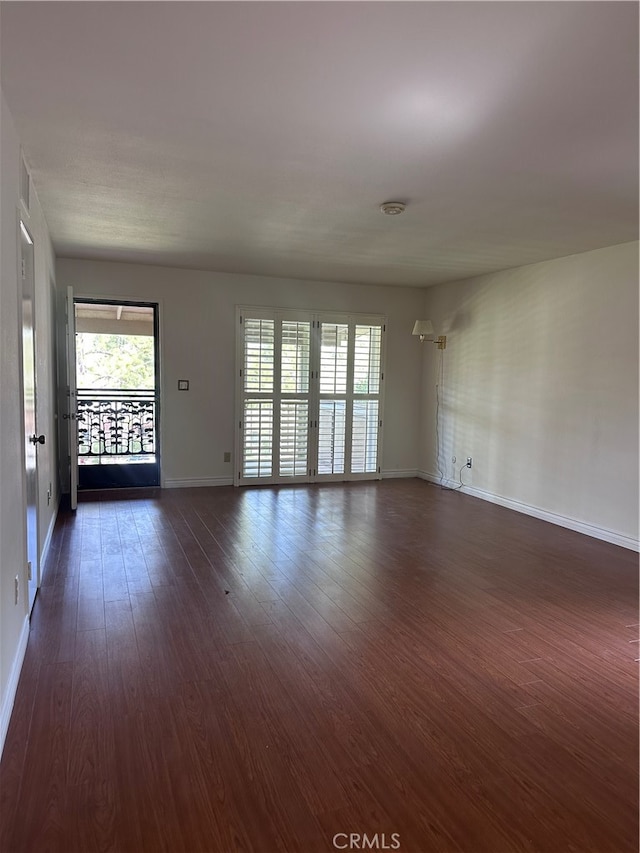 unfurnished living room with dark wood-type flooring