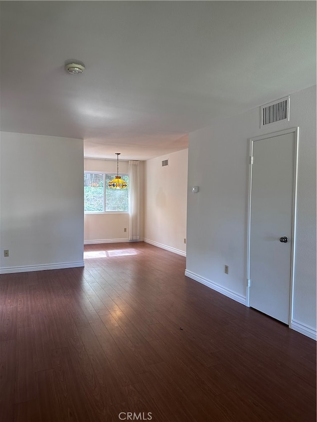 spare room featuring dark hardwood / wood-style floors