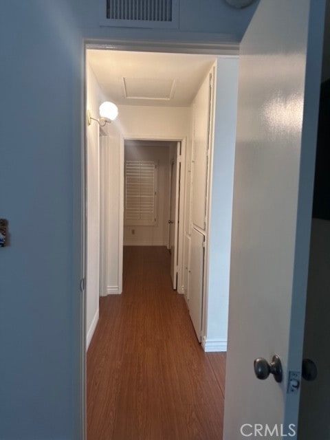 hallway with hardwood / wood-style flooring