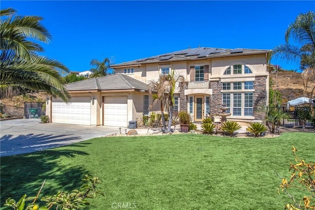 view of front of house with french doors, solar panels, a balcony, a front lawn, and a garage