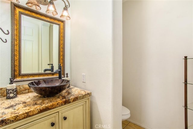 bathroom with tile patterned floors, vanity, and toilet