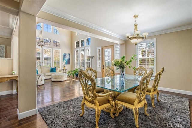 dining room featuring crown molding, dark hardwood / wood-style flooring, and a notable chandelier