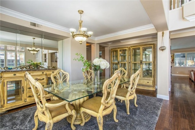 dining room featuring dark hardwood / wood-style floors, a healthy amount of sunlight, and a chandelier