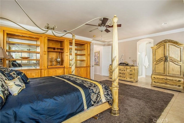 bedroom featuring ceiling fan, light tile patterned floors, and crown molding