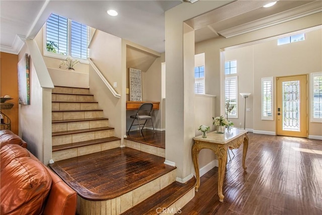 entrance foyer featuring hardwood / wood-style flooring and crown molding