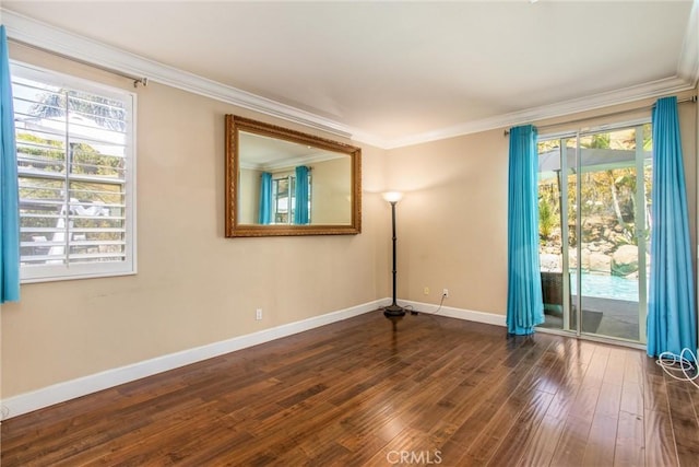 empty room featuring dark hardwood / wood-style floors and ornamental molding