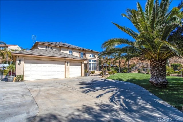 view of front of house featuring a front yard and a garage