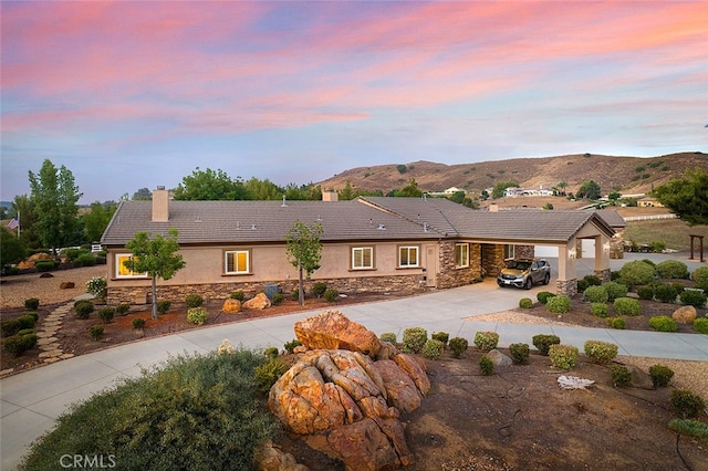 view of front facade with a mountain view and a carport