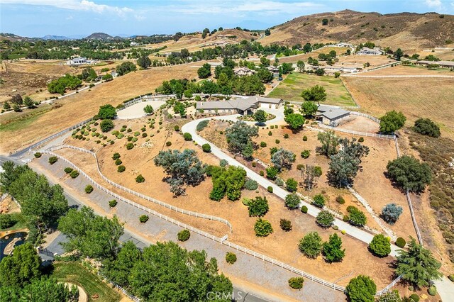 drone / aerial view with a mountain view and a rural view