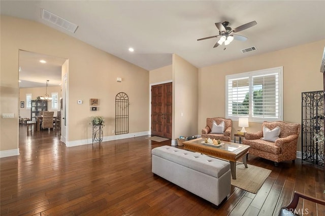 living room with ceiling fan, dark hardwood / wood-style flooring, and vaulted ceiling