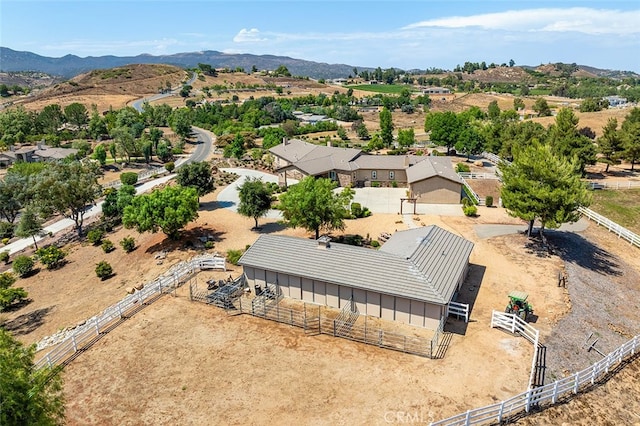 birds eye view of property featuring a mountain view and a rural view