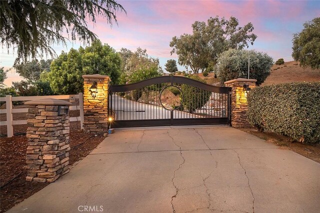 view of gate at dusk