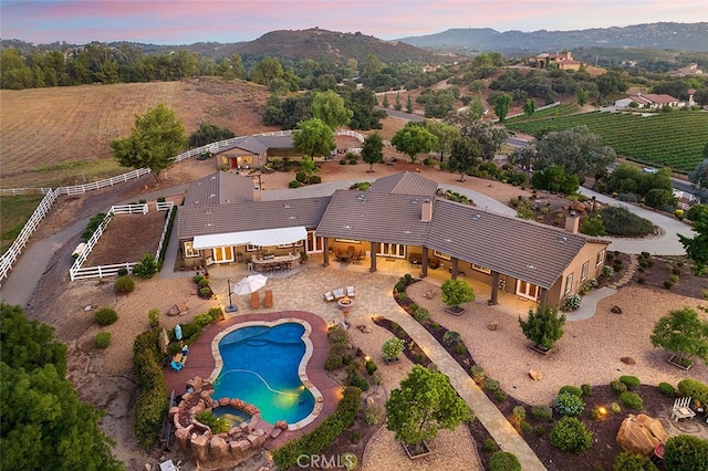 aerial view at dusk featuring a mountain view