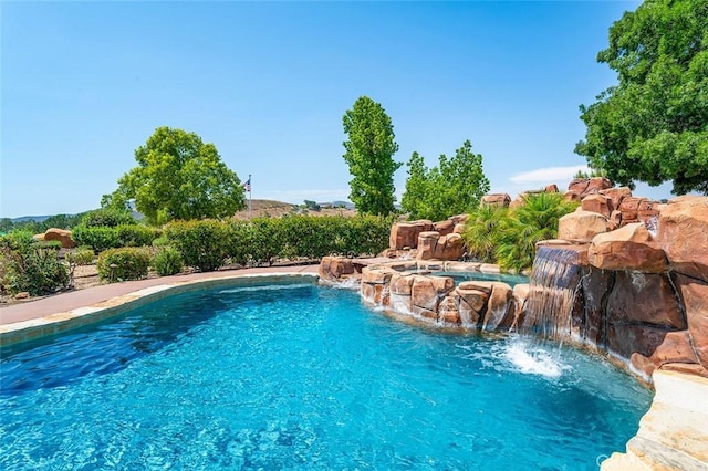 view of pool with pool water feature