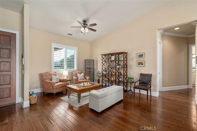 living room featuring ceiling fan, dark hardwood / wood-style flooring, vaulted ceiling, and ornamental molding