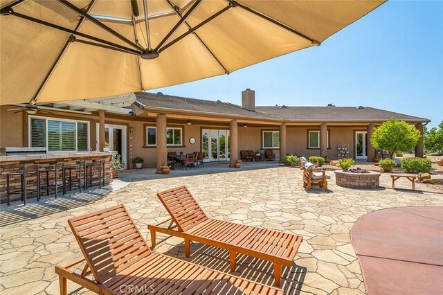 back of house featuring a patio, an outdoor bar, and an outdoor fire pit