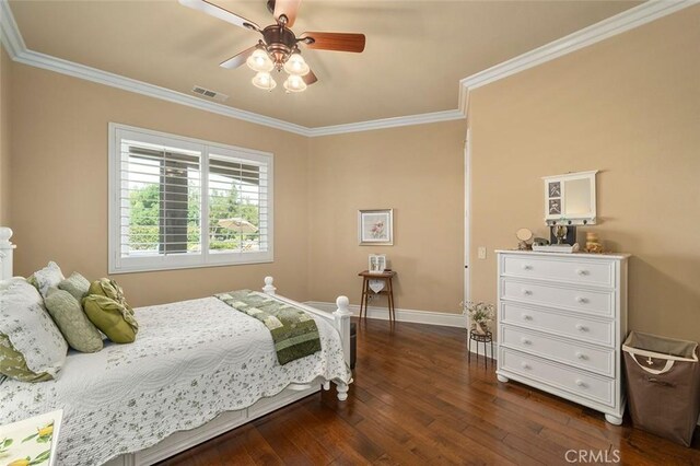 bedroom featuring ceiling fan, ornamental molding, and dark wood-type flooring