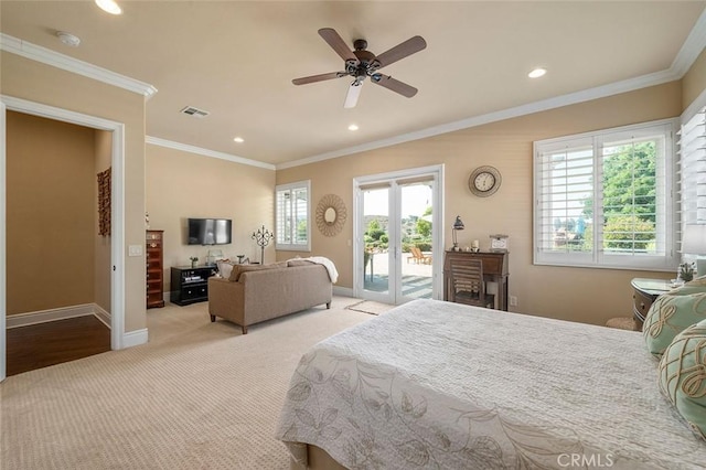 carpeted bedroom featuring access to exterior, ceiling fan, multiple windows, and ornamental molding