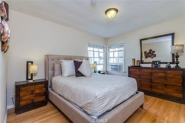 bedroom with light wood-type flooring and cooling unit