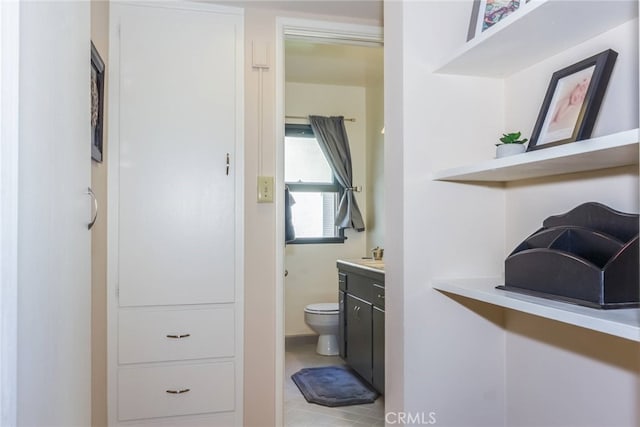 bathroom with vanity, tile patterned flooring, and toilet