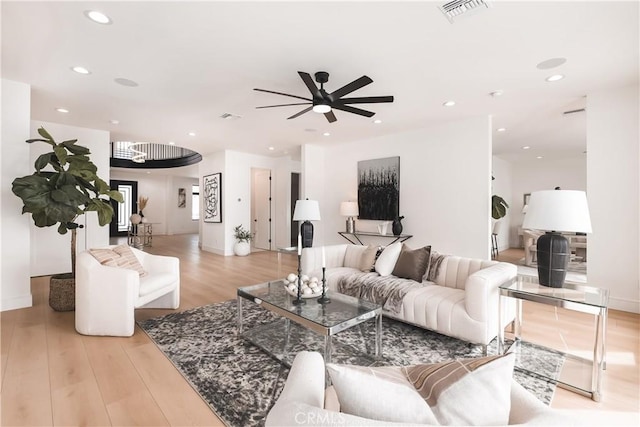 living room featuring ceiling fan and light wood-type flooring