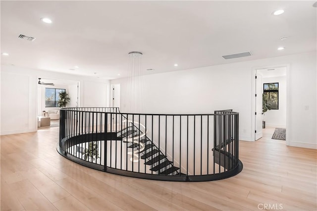 hallway with light hardwood / wood-style flooring