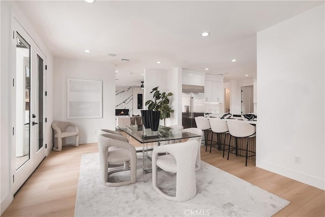 dining space with light hardwood / wood-style flooring