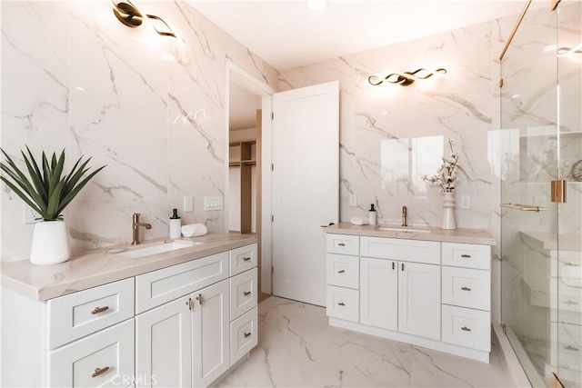 bathroom with vanity and a shower with shower door