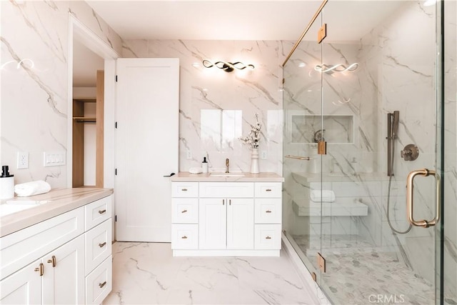 bathroom with vanity and a shower with door