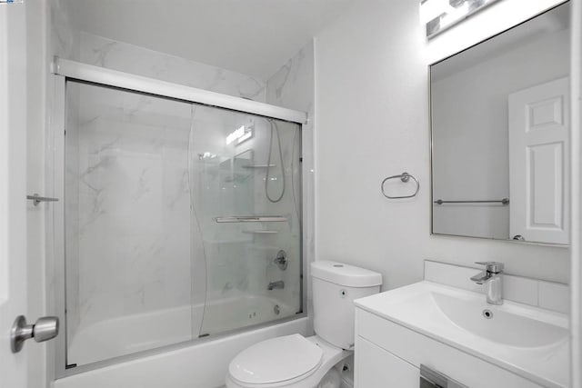 full bathroom featuring vanity, enclosed tub / shower combo, and toilet